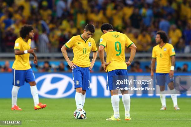 Oscar and Fred of Brazil prepare to kick off after a goal during the 2014 FIFA World Cup Brazil Semi Final match between Brazil and Germany at...