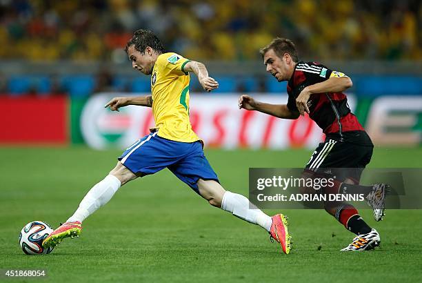 Germany's defender and captain Philipp Lahm vies withBrazil's forward Bernard during the semi-final football match between Brazil and Germany at The...