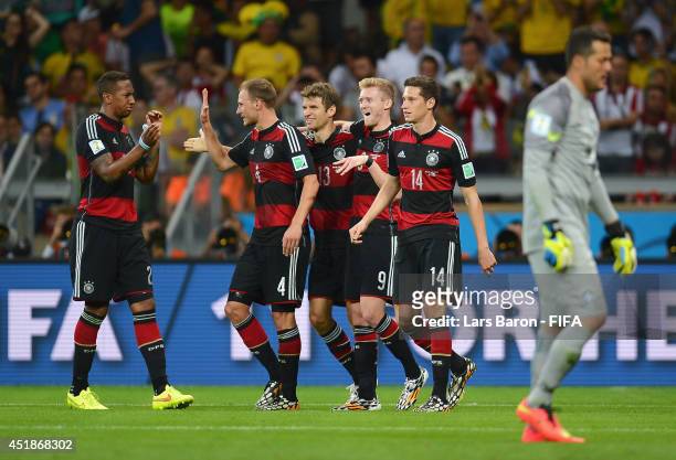 Andre Schuerrle of Germany celebrates scoring his team's seventh goal with his teammates Jerome Boateng , Benedikt Hoewedes , Thomas Mueller and...