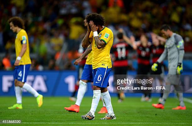 Marcelo of Brazil reacts after conceding the seventh goal to Germany during the 2014 FIFA World Cup Brazil Semi Final match between Brazil and...