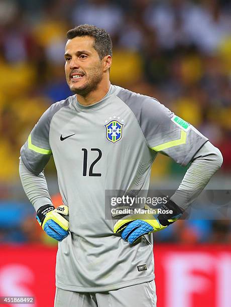 Goalkeeper Julio Cesar of Brazil looks dejected after allowing a goal during the 2014 FIFA World Cup Brazil Semi Final match between Brazil and...