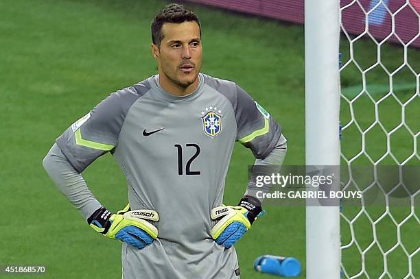 Brazil's goalkeeper Julio Cesar reacts after Germany's seventh goal during the semi-final football match between Brazil and Germany at The Mineirao...