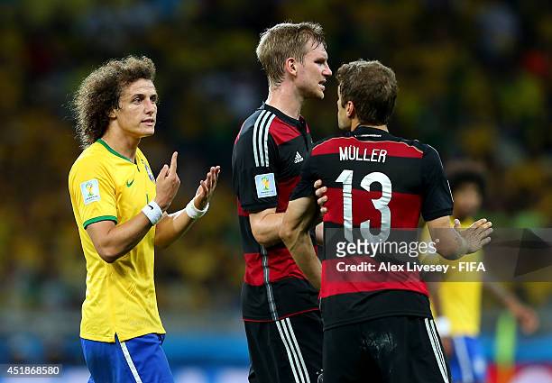 David Luiz of Brazil and Thomas Mueller of Germany argue during the 2014 FIFA World Cup Brazil Semi Final match between Brazil and Germany at Estadio...