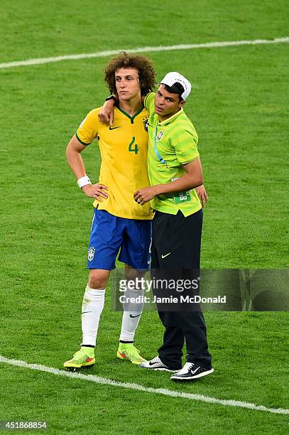 Thiago Silva of Brazil consoles David Luiz after Germany's 7-1 victory during the 2014 FIFA World Cup Brazil Semi Final match between Brazil and...