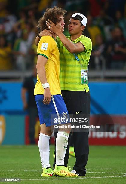 Thiago Silva of Brazil consoles teammate David Luiz after Germany's 7-1 victory during the 2014 FIFA World Cup Brazil Semi Final match between Brazil...