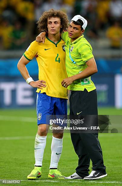 David Luiz of Brazil is consoled by Thiago Silva after the 2014 FIFA World Cup Brazil Semi Final match between Brazil and Germany at Estadio Mineirao...