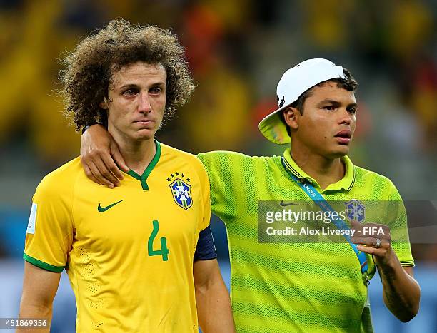 David Luiz of Brazil is consoled by Thiago Silva after the 2014 FIFA World Cup Brazil Semi Final match between Brazil and Germany at Estadio Mineirao...