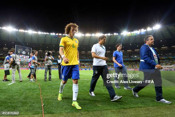 David Luiz of Brazil shows his dejection while walking off the pitch after the 1-7 defeat in the 2014 FIFA World Cup Brazil Semi Final match between...