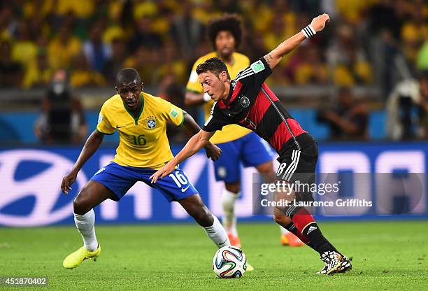 Mesut Oezil of Germany controls the ball as Ramires of Brazil looks on during the 2014 FIFA World Cup Brazil Semi Final match between Brazil and...
