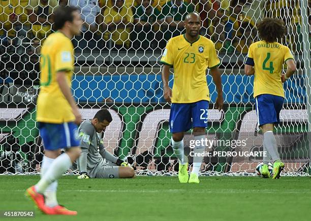 Brazil's forward Bernard, Brazil's goalkeeper Julio Cesar, Brazil's defender Maicon and Brazil's defender David Luiz react after the sixth German...