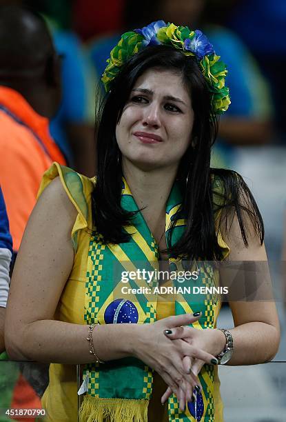 Brazilian fan reacts at the end of the semi-final football match between Brazil and Germany at The Mineirao Stadium in Belo Horizonte during the 2014...