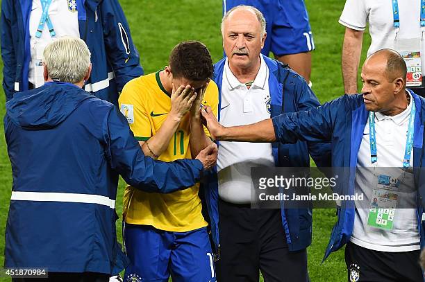 Head coach Luiz Felipe Scolari of Brazil and staff console Oscar after a 7-1 defeat to Germany during the 2014 FIFA World Cup Brazil Semi Final match...