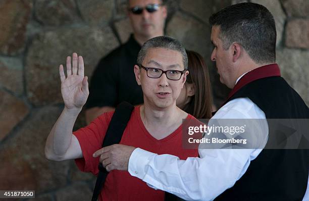 Victor Koo, chief executive officer of Youku Inc., center, arrives at the Sun Valley Lodge ahead of the Allen & Co. Media and Technology Conference...