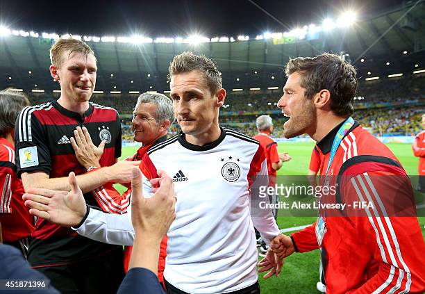 Miroslav Klose of Germany celebrates the 7-1 win while walking off the pitch after the 2014 FIFA World Cup Brazil Semi Final match between Brazil and...