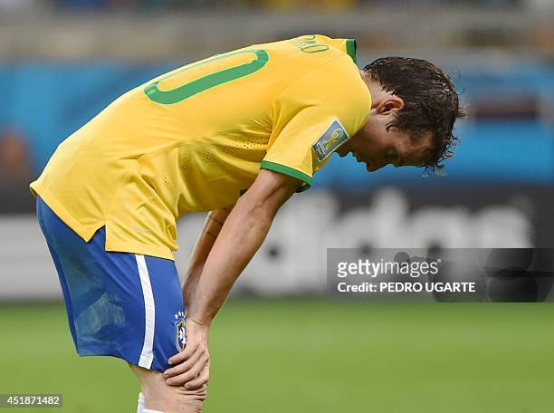 Brazil's forward Bernard reacts after the semi-final football match between Brazil and Germany at The Mineirao Stadium in Belo Horizonte during the...
