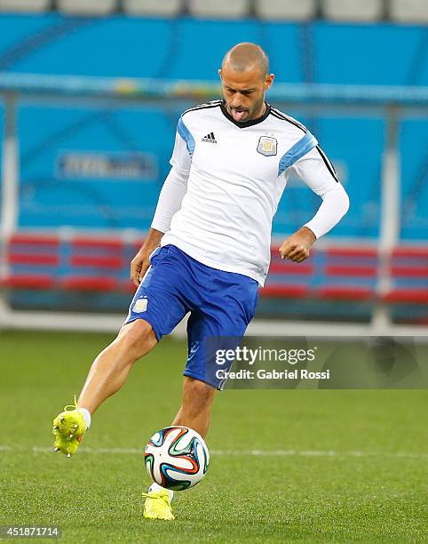 Javier Mascherano controls the ball during a training session at Arena Corinthians on July 08, 2014 in Sao Paulo, Brazil. Argentina will face The...