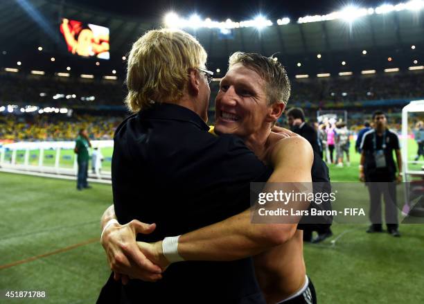 Bastian Schweinsteiger of Germany celebrates the 7-1 win with chief scout Urs Siegenthaler after the 2014 FIFA World Cup Brazil Semi Final match...