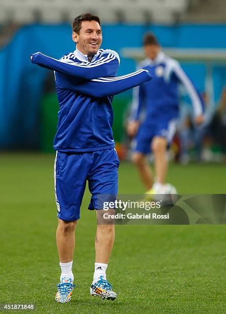 Lionel Messi warms up during a training session at Arena Corinthians on July 08, 2014 in Sao Paulo, Brazil. Argentina will face The Netherlands as...