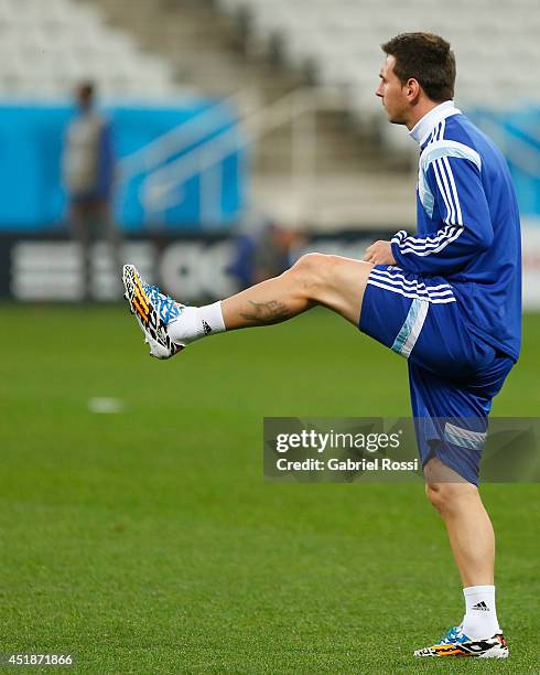 Lionel Messi warms up during a training session at Arena Corinthians on July 08, 2014 in Sao Paulo, Brazil. Argentina will face The Netherlands as...