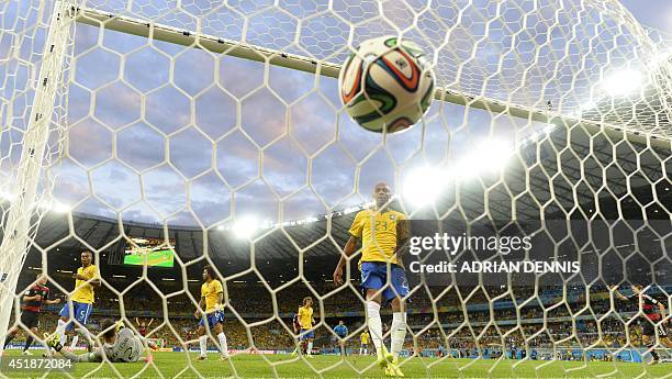 Brazil's goalkeeper Julio Cesar concedes a goal during the semi-final football match between Brazil and Germany at The Mineirao Stadium in Belo...