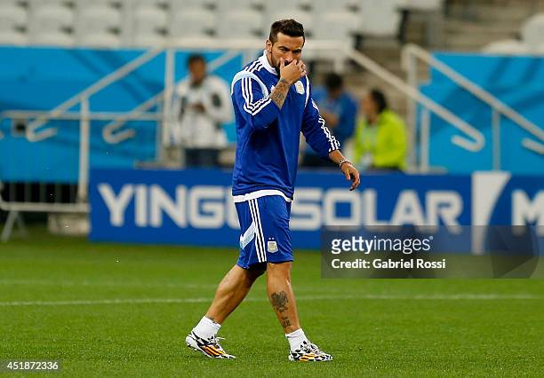 Ezequiel Lavezzi gestures while he walks during a training session at Arena Corinthians on July 08, 2014 in Sao Paulo, Brazil. Argentina will face...