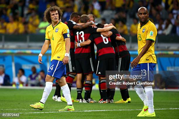 David Luiz and Maicon of Brazil look dejected after allowing Germany's fifth goal during the 2014 FIFA World Cup Brazil Semi Final match between...