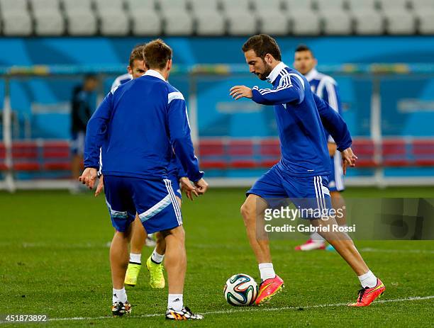 Gonzalo Higuaín controls the ball during a training session at Arena Corinthians on July 08, 2014 in Sao Paulo, Brazil. Argentina will face The...