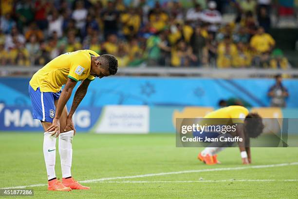 Luiz Gustavo and Marcelo Vieira of Brazil look dejected after the 2014 FIFA World Cup Brazil Semi Final match between Brazil and Germany at Estadio...