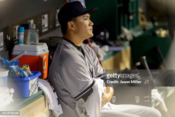 Starting pitcher Masahiro Tanaka of the New York Yankees sits in the dugout after leaving the game during the seventh inning against the Cleveland...