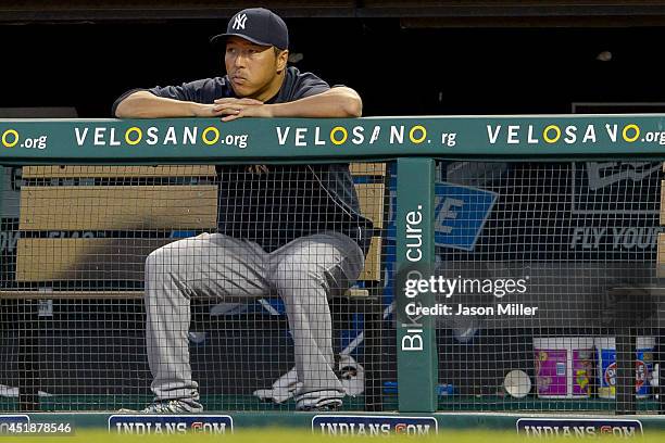 Hiroki Kuroda of the New York Yankees watches the game from the dugout during the sixth inning against the Cleveland Indians at Progressive Field on...