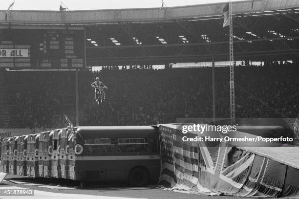 American motorcycle stunt rider Evel Knievel attempts to jump 13 AEC Merlin buses at Wembley Stadium, London, 26th May 1975. Knievel crashed his...