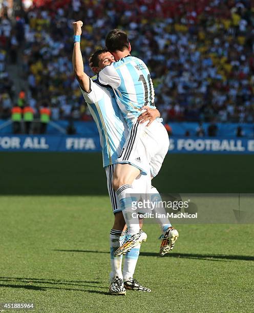 Lionel Messi and Angel Di Maria of Argentina celebrate during the 2014 FIFA World Cup Brazil Round of 16 match between Argentina and Switzerland at...