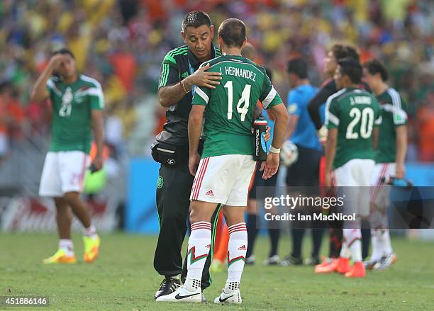 Dejected Javier 'Chicharito' Hernandez of Mexico is comforted during the Round of 16 match of the 2014 World Cup between Netherlands and Mexico at...