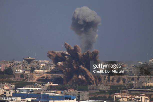 Plume of smoke rises over Gaza following an Israel Air Force bombing, as seen from near Sderot on July 9, 2014 in Israel. Due to recent escalation in...
