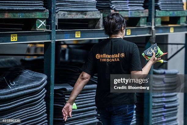 Lengths of rubber sit in storage racks ahead of moulding into automobile tires at the Continental AG plant in Timisoara, Romania, on Wednesday, June...