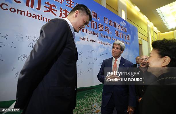 Secretary of State John Kerry talks with retired Chinese NBA basketball star Yao Ming about his efforts against international wildlife trafficking as...