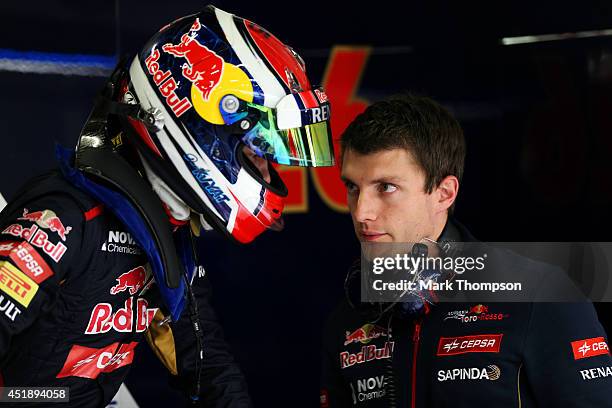 Daniil Kvyat of Russia and Scuderia Toro Rosso speaks with a member of his team in the garage during day two of testing at Silverstone Circuit on...