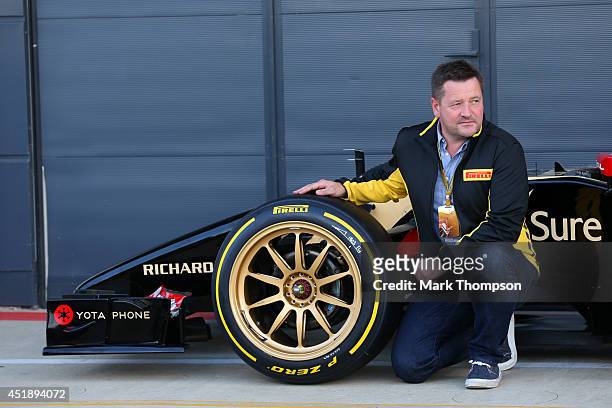 Paul Hembery, Motorsport Director of Pirelli poses with the new 18-inch Pirelli wheels, fitted on a Lotus, before demonstration runs during day two...