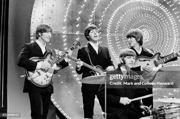 The Beatles perform 'Rain' and 'Paperback Writer' on BBC TV show 'Top Of The Pops' in London on 16th June 1966. Left to right: John Lennon , Paul...