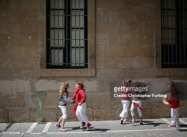Children sing and dance on the street during the fourth day of the San Fermin Running Of The Bulls festival, on July 9, 2014 in Pamplona, Spain. The...