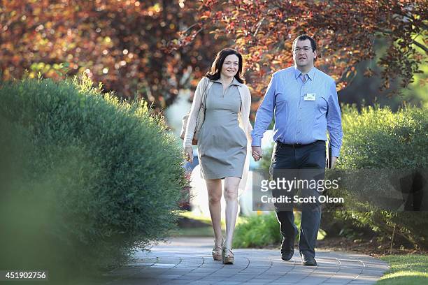 Sheryl Sandberg, chief operating officer of Facebook, and her husband David Goldberg, CEO of SurveyMonkey, attend the Allen & Company Sun Valley...