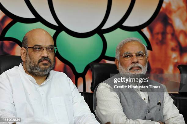 Prime Minister Narendra Modi along with newly appointed BJP President Amit Shah at the BJP headquarters on July 9, 2014 in New Delhi, India. A close...