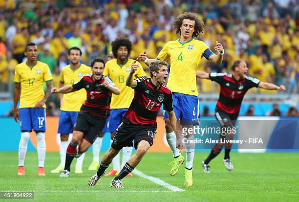 Thomas Mueller of Germany celebrates scoring his team's first goal during the 2014 FIFA World Cup Brazil Semi Final match between Brazil and Germany...