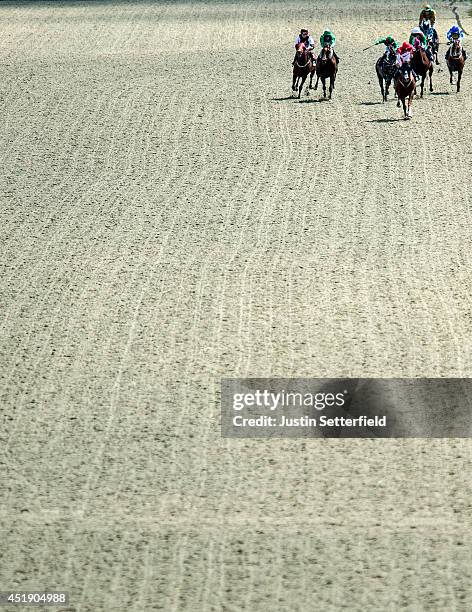 Well Painted riden by Robert Tart leads the pack in the 32Red Selling Stakes at Lingfield Park on July 9, 2014 in Lingfield, England.