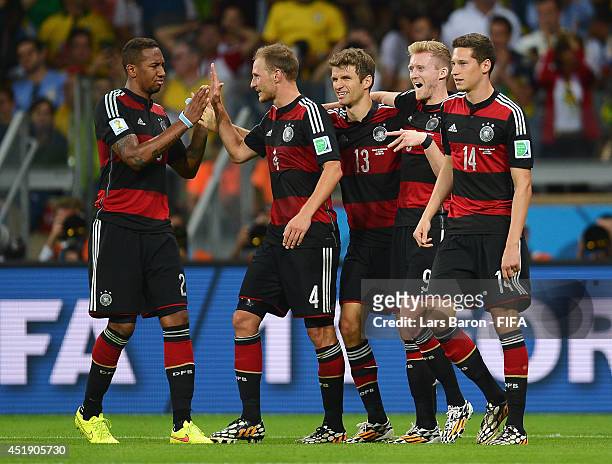 Andre Schuerrle of Germany celebrates scoring his team's seventh goal with his teammates Jerome Boateng , Benedikt Hoewedes , Thomas Mueller and...
