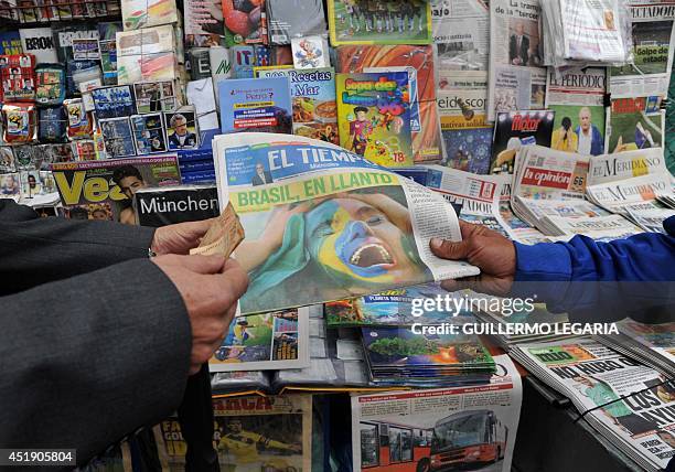 Man buys a newspaper at a newsstand in Bogota on July 9 a day after Germany beat Brazil with a record 7-1 victory in their FIFA World Cup Brazil 2014...