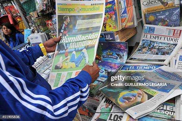 Man reads a newspaper at a newsstand in Bogota on July 9 a day after Germany beat Brazil with a record 7-1 victory in their FIFA World Cup Brazil...