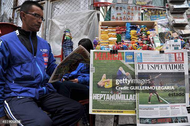 Man reads a newspaper at a newsstand in Bogota on July 9 a day after Germany beat Brazil with a record 7-1 victory in their FIFA World Cup Brazil...