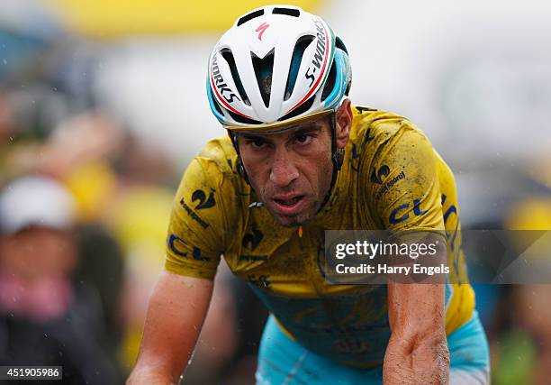 Vincenzo Nibali of Italy and team Astana crosses the line in third place to retain the yellow jersey during the fifth stage of the 2014 Tour de...