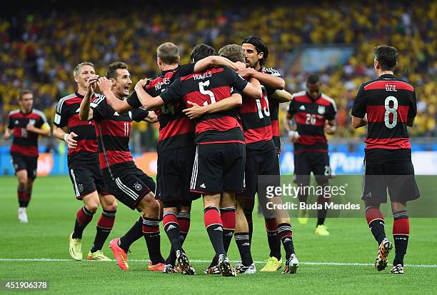 Thomas Mueller of Germany celebrates with his team-mates after scoring the opening goal during the 2014 FIFA World Cup Brazil Semi Final match...